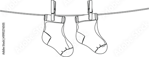 Two baby socks hanging on a clothesline with clothespins
