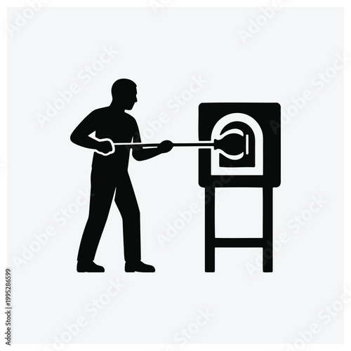 Man using a blowpipe or bellows at a smithy or forge