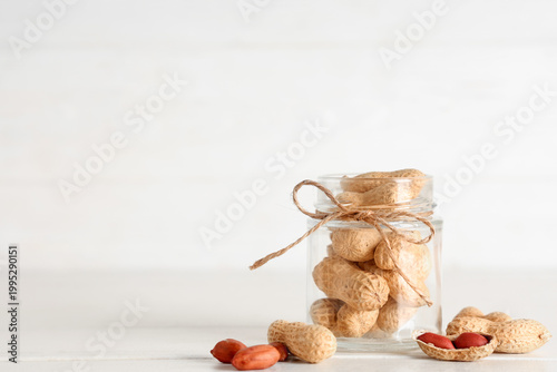 Jar with unpeeled peanuts o...