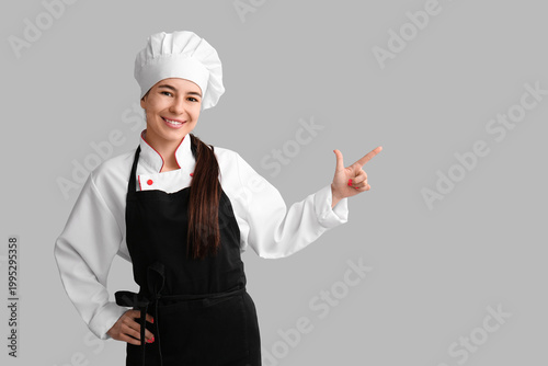 Young female chef pointing ...