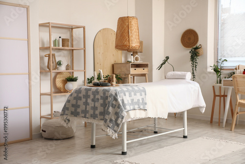 Interior of massage therapist's office with shelving unit, houseplants and sp...