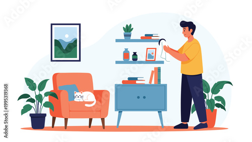 Young man diligently dusts a shelf in a modern living room while a white cat sleeps comfortably on a nearby orange armchair.