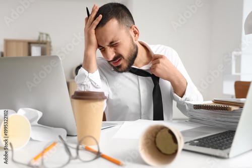 Stressed businessman workin...