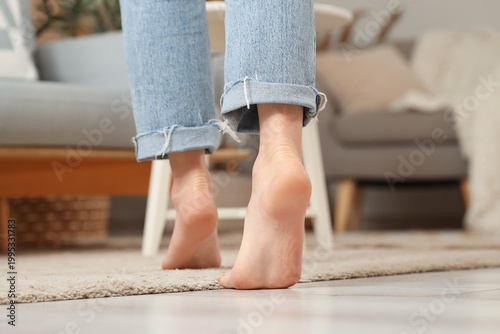 Barefoot woman in rolled up...