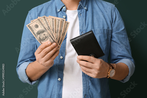 Man holding wallet and mone...