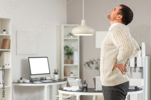Schilderij op canvas Young businessman suffering from lumbar pain in office