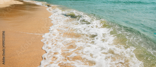 Bild auf Leinwand Gentle sea waves on the sandy beach shore.
