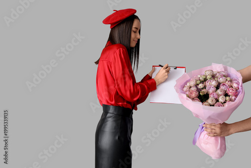 Young woman receiving bouqu...