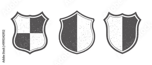 Three distressed dark gray heraldic shields with white outlines emblem crest badge