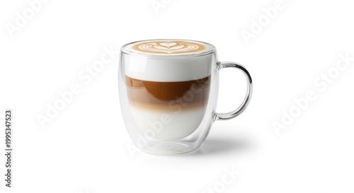 A clear glass mug containing layers of frothy milk, brown liquid, and a heart design on top