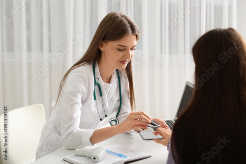 Beautiful doctor taking pul...