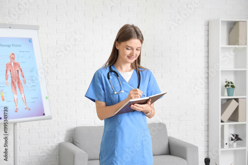 Beautiful doctor writing in...