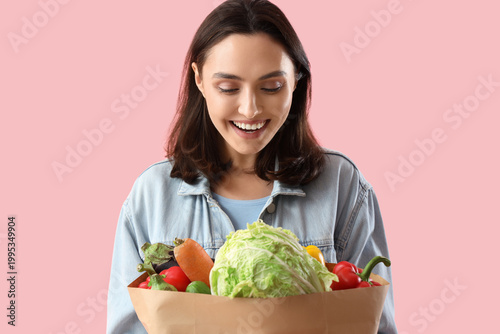 Young woman with paper bag ...