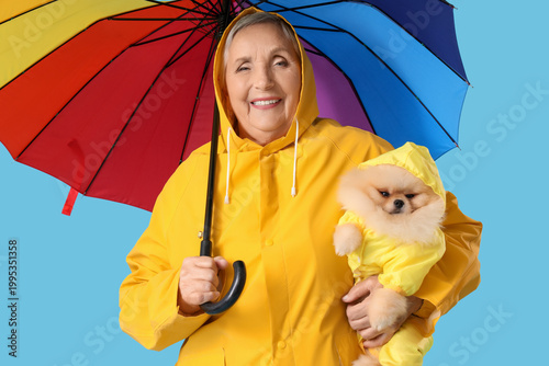 Senior woman in raincoat wi...
