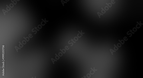 Abstract black and dark gray gradient background, with soft blurred, light patches