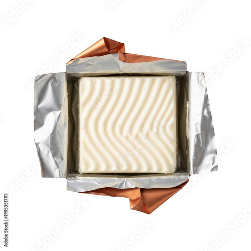 A block of butter wrapped in silver and orange foil on transparent background