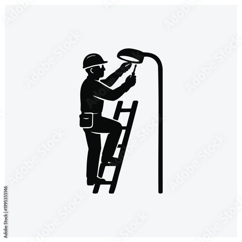 Worker repairing streetlight on ladder silhouette