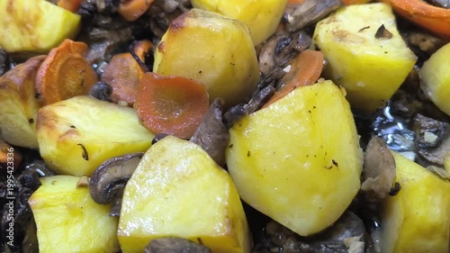 fried potatoes with mushrooms on a baking sheet