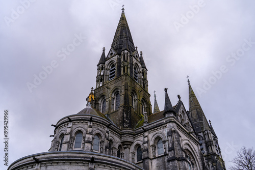 St. Fin Barre's Cathedral, Cork, Ireland, under a cloudy sky.