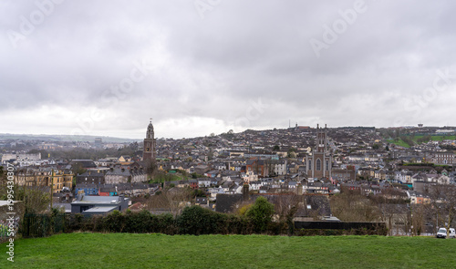 Panoramic view of Cork city skyline under cloudy skies.