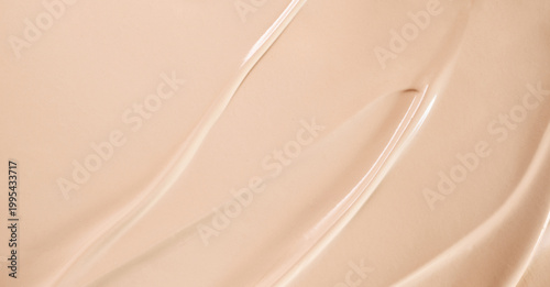 Konstfotografi Beige liquid foundation creating smooth and creamy cosmetic texture with abstrac
