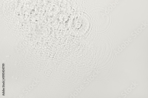 Transparent liquid creating abstract patterns with splashes