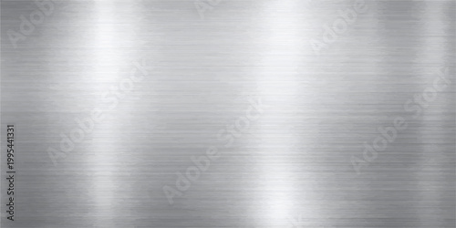 Industrial brushed metal texture featuring a polished silver stainless steel plate with a shiny grey metallic pattern on a sleek aluminum surface backdrop