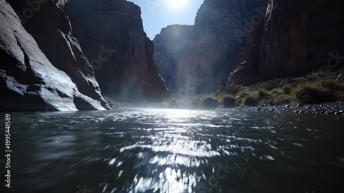 Beautiful river flowing through a canyon with sunlight shining.