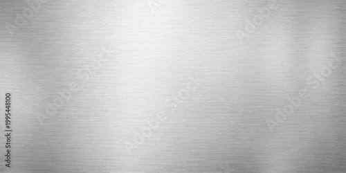 A shiny stainless steel plate with a brushed metal texture creates a gray industrial background featuring a polished silver aluminum surface and a metallic alloy pattern sheet
