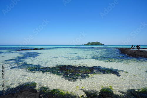 clear shoaling beach and far island