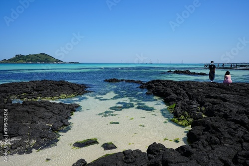 clear shoaling beach and far island