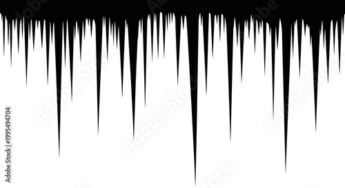 Sharp jagged black icicles hang precariously from an unseen overhang creating a dramatic frosty border against a stark white background evoking winter's chill and the beauty