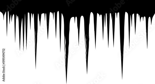 Sharp jagged icicles hang precariously from an unseen edge creating a dramatic frosty silhouette against a stark white background evoking winter's cold embrace and the stark