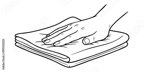A hand pressing down on a folded stack of papers on a surface.