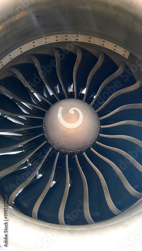 Fotografie Close up of jet engine intake fan blades and spinner with spiral mark inside com
