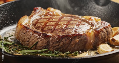 Juicy ribeye steak sizzling in a cast iron skillet with herbs and garlic, perfect for gourmet cooking