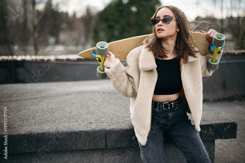 Stylish Woman with Skateboard Outdoors