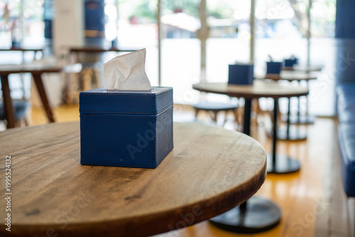 Blue Tissue Box on Wooden Table Inside Cozy Cafe
