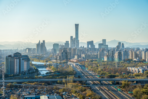 Modern urban landscape of China's capital with distant mountains under clear sky