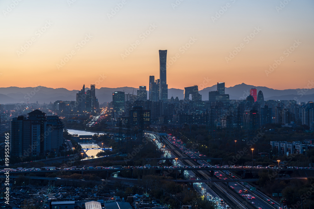 Naklejka premium Prosperous urban buildings in Beijing, China at dusk with sunset glow
