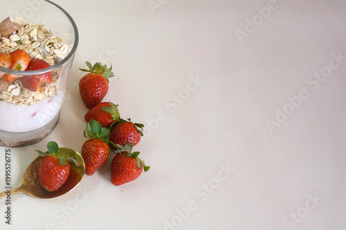 Close Up Of Healthy Diet Food With Granola, Fresh Strawberry And Yoghurt In A Glass, Decorated With Strawberries And Golden Spoon. Copy Space For Text.