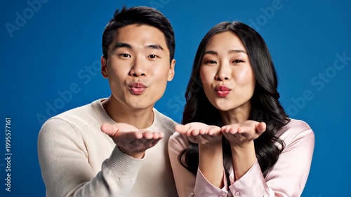 Asian Couple Blowing Kisses and Laughing Together.