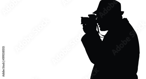 A silhouetted photographer with a camera focused on capturing a moment against a stark white background