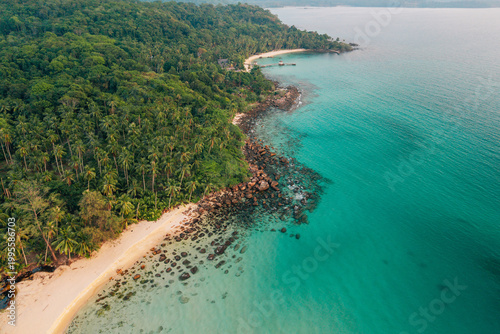 Obraz na płótnie Aerial landscape of a lush tropical island coastline with clear blue sea
