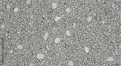 Small grey pebbles texture natural stone floor background.