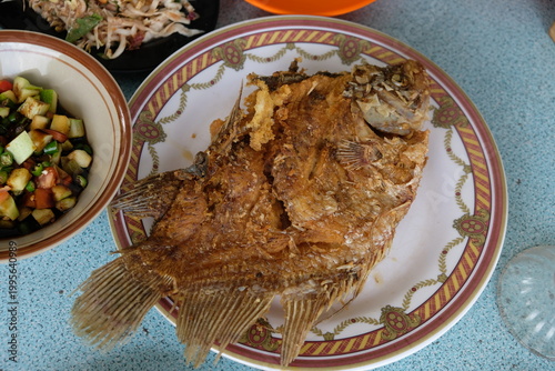 Fried gourami fish on the plate. Freshwater fish 