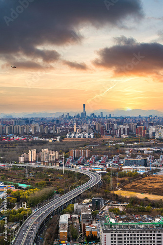 Panoramic view of Beijing city skyline and urban fabric glowing in the sunset afterglow, China