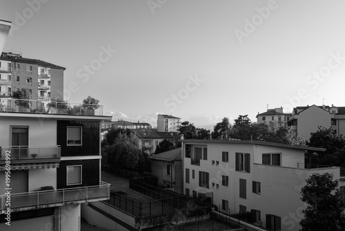 Residential buildings and rooftops in Italian city with distant mountains