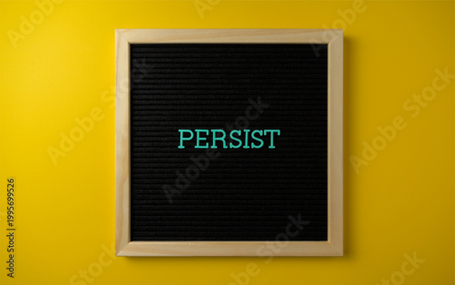 Photos Motivational letter board with the word persist on a yellow background