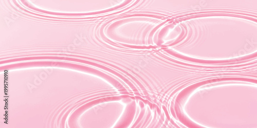 Abstract pink water ripples with circles spreading on the liquid surface